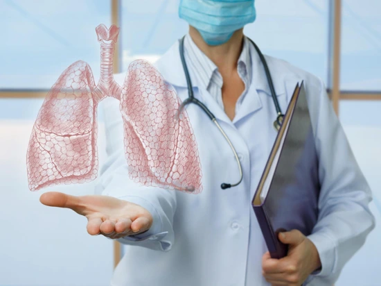 Doctor holding a 3D-rendered image of a human lung.