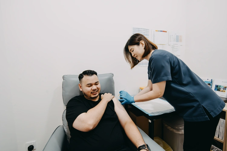 Patient receiving vaccination from nurse at ATA Medical (Jurong) Clinic.