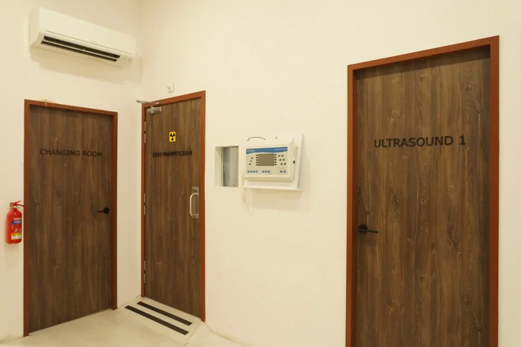 Modern screening rooms with labelled doors for X-ray and ultrasound at ATA Medical.
