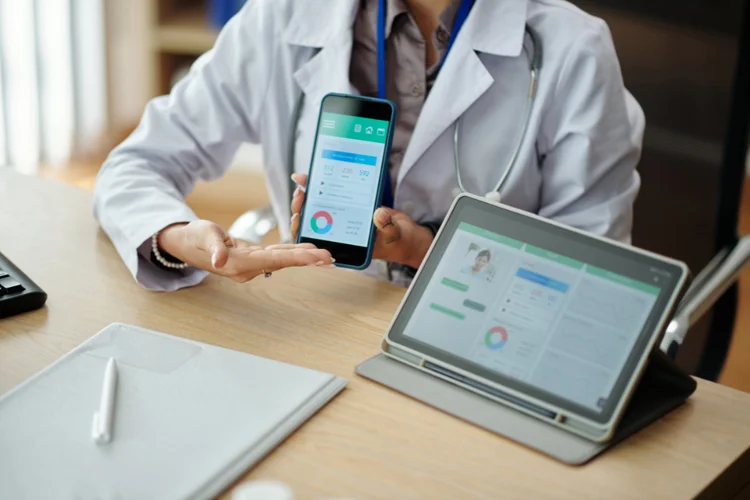 Doctor reviewing health screening results on tablet to patient as part of longevity clinic services.