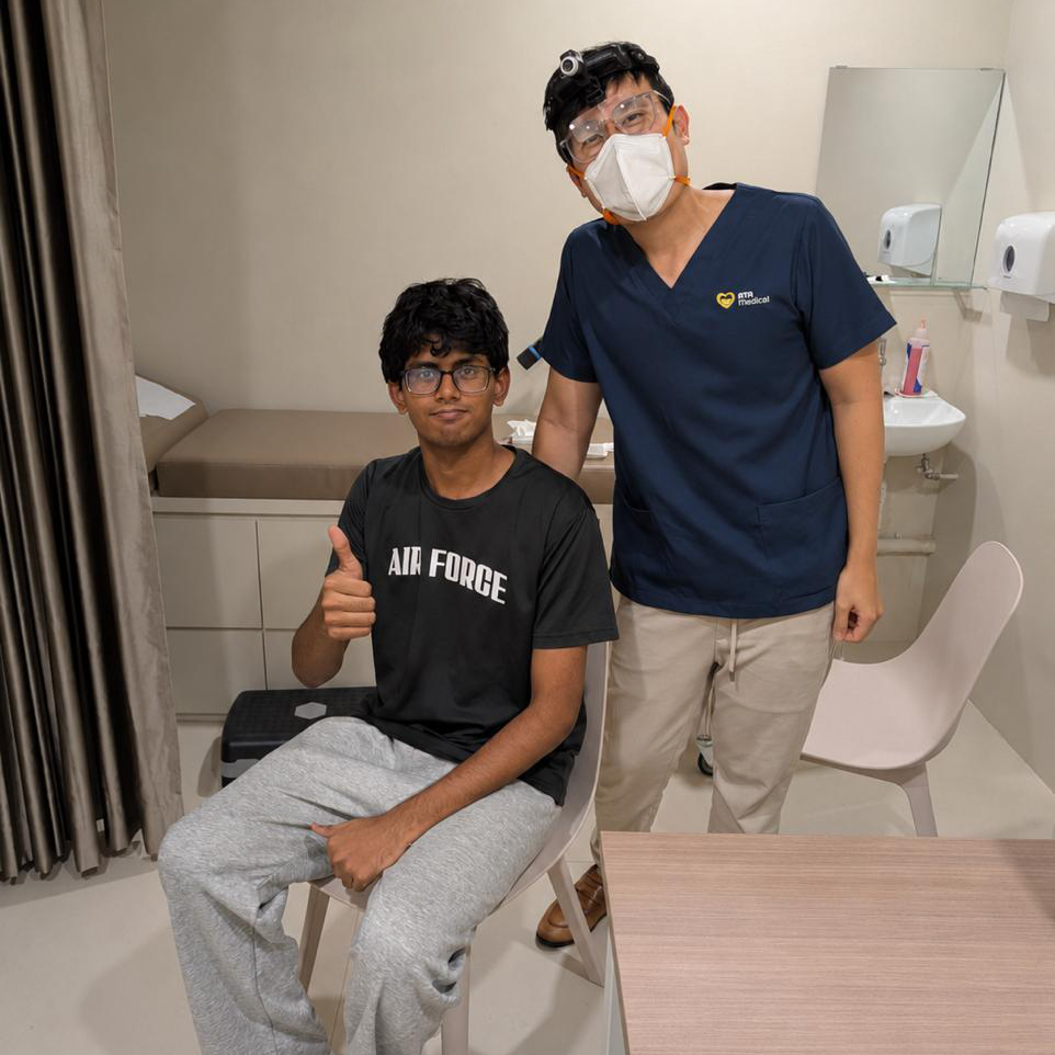 Dr Joel Foo of ATA Medical with a patient after a successful ear wax removal procedure at the Jurong clinic.