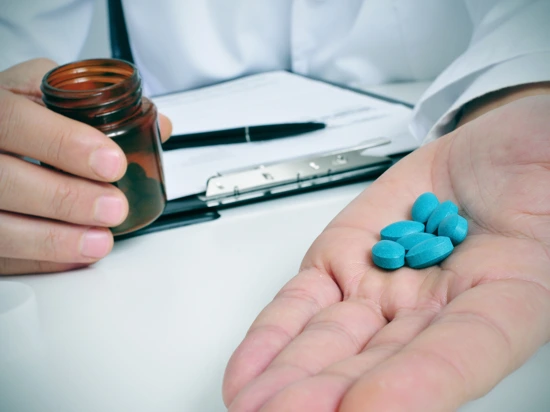 Doctor issuing a male patient viagra to cure his Erectile Dysfunction (ED) problems.