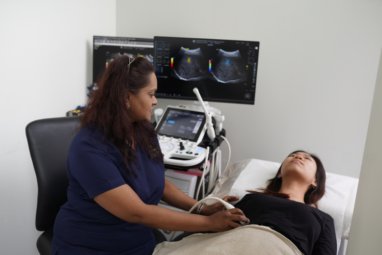 Radiographer performing liver ultrasound scan to assess fat levels and liver health.