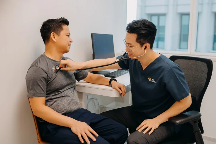 Dr Leonard Leng of ATA Medical using a stethoscope to listen to patient's internal sounds from his chest.