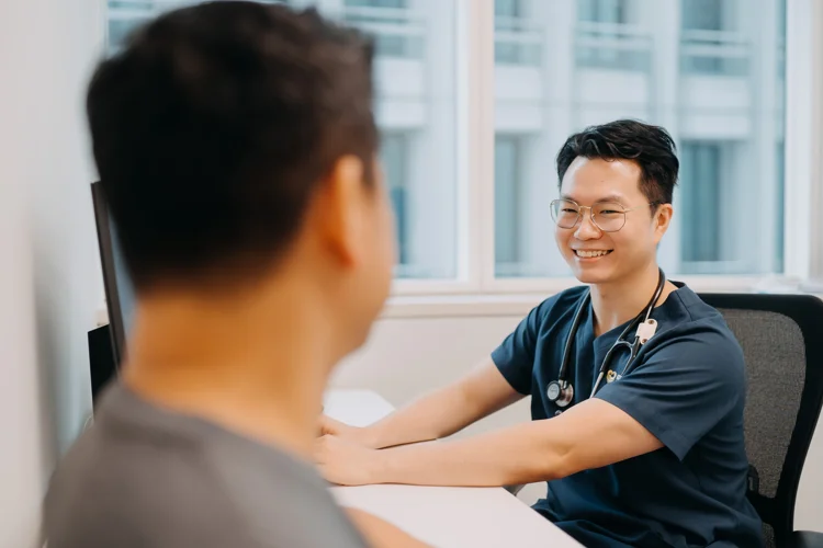 Dr Leonard Leng of ATA Medical having a post-consultation with male patient to discuss the results of his blood test.