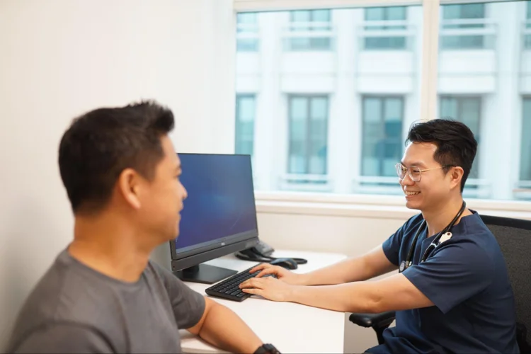 Dr Leonard Leng of ATA Medical having a consultation session with patient before the health screening process.