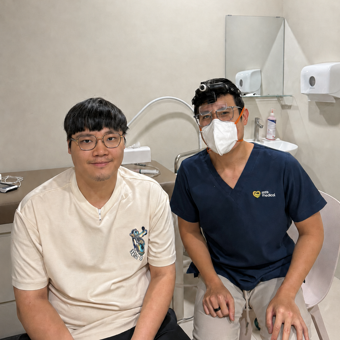 Seated patient with Dr Joel Foo of ATA Medical after an ear wax removal procedure at the Jurong clinic.
