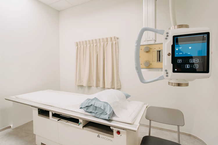 Digital X-ray imaging machine with examination table at ATA Medical Novena clinic.