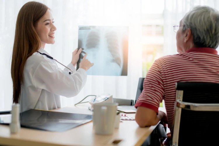 Doctor discussing the results of X-Ray scan with patient.