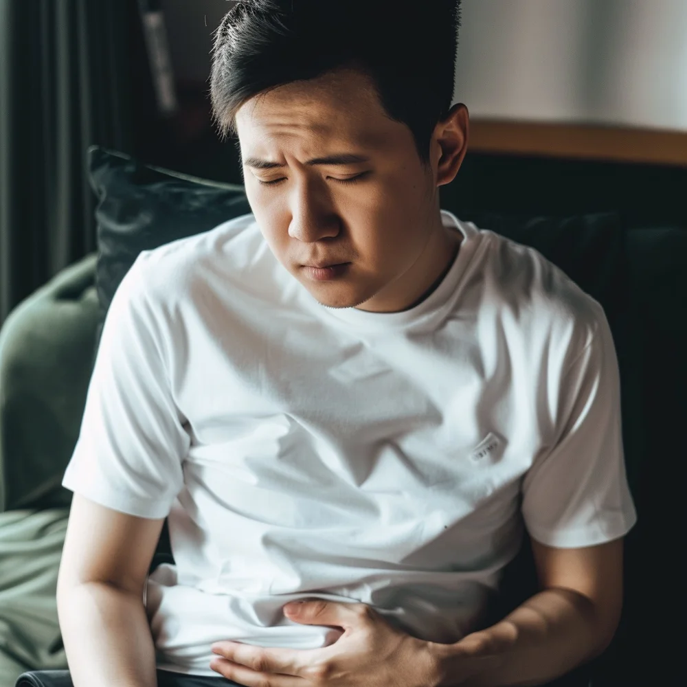 Young asian man experiencing severe abdominal pain from severe dengue.